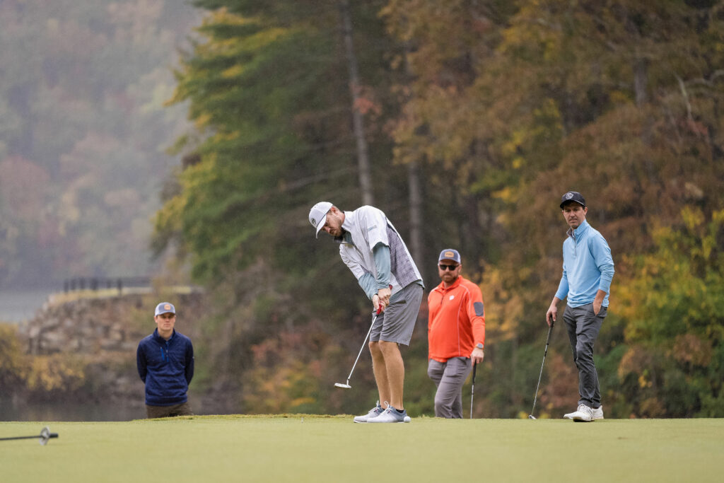 People playing golf on course.